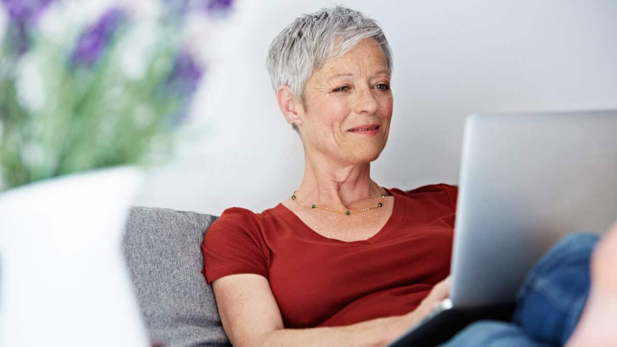 Woman using her laptop with her feet up.