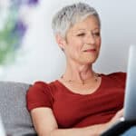 Woman using her laptop with her feet up.