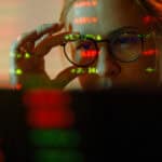 Woman looking at stock market numbers.