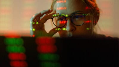 Woman looking at stock market numbers.