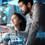 Man working with his colleague with a hologram of a world map.