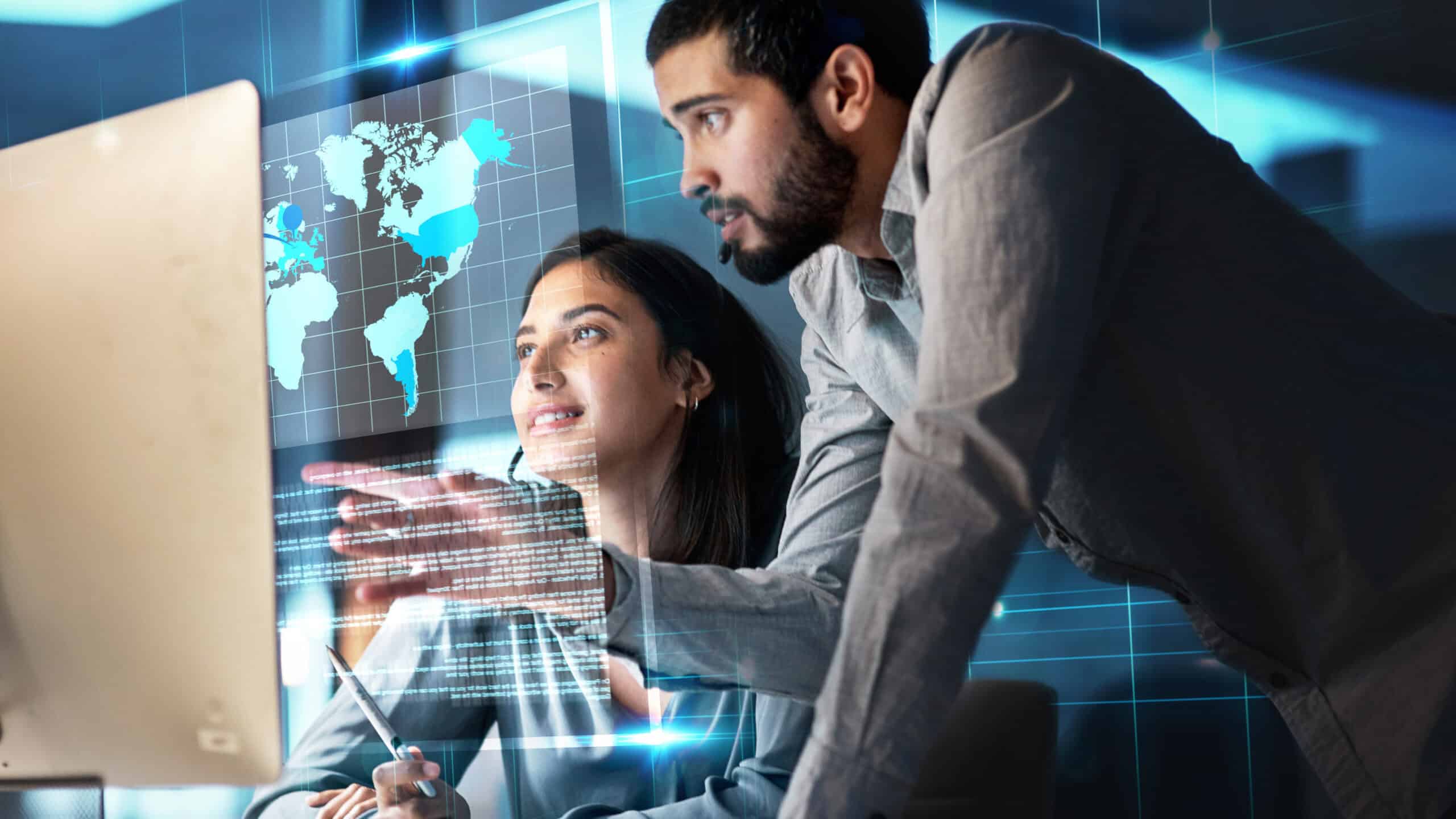 Man working with his colleague with a hologram of a world map.