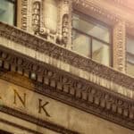 Bank written on a brown building.