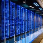 View of a row of blue and black server racks in a data centre.