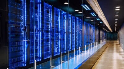 View of a row of blue and black server racks in a data centre.
