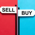 Buy and sell signs amidst blue and red backgrounds.