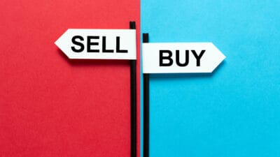 Buy and sell signs amidst blue and red backgrounds.