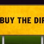 Buy the dip written on a yellow sign.