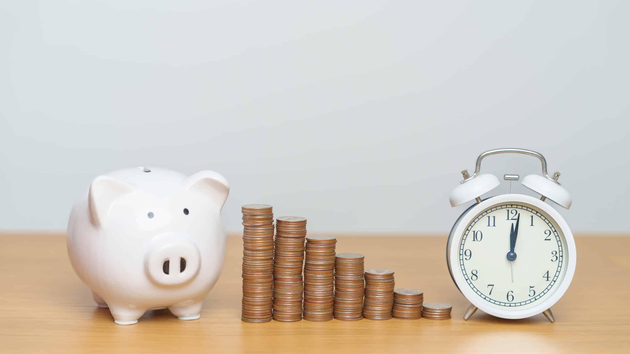 Coins in ascending order from left to right, with a piggy bank and clock on the sides.