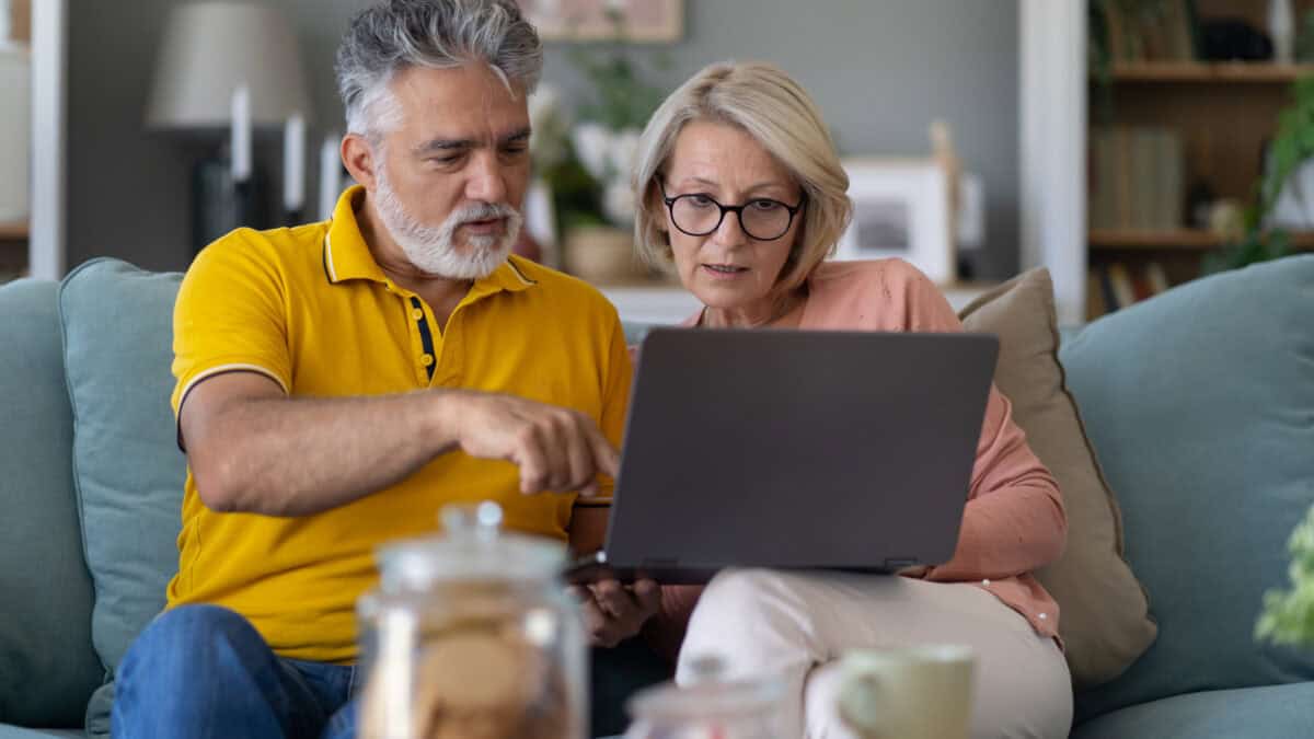 Senior couple looking at a laptop.