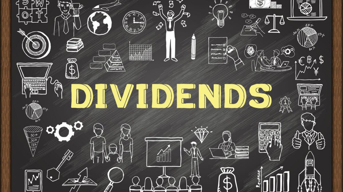 Dividends written in yellow on chalkboard, with finance-related diagrams.