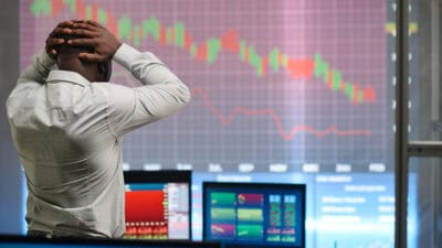 Man looking at graph decreasing and feeling disappointment.