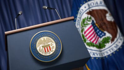 Press conference set up with symbol and flag of Federal Reserve.