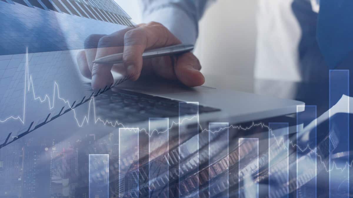Man working in office with finance graph on virtual screen.