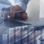 Man working in office with finance graph on virtual screen.