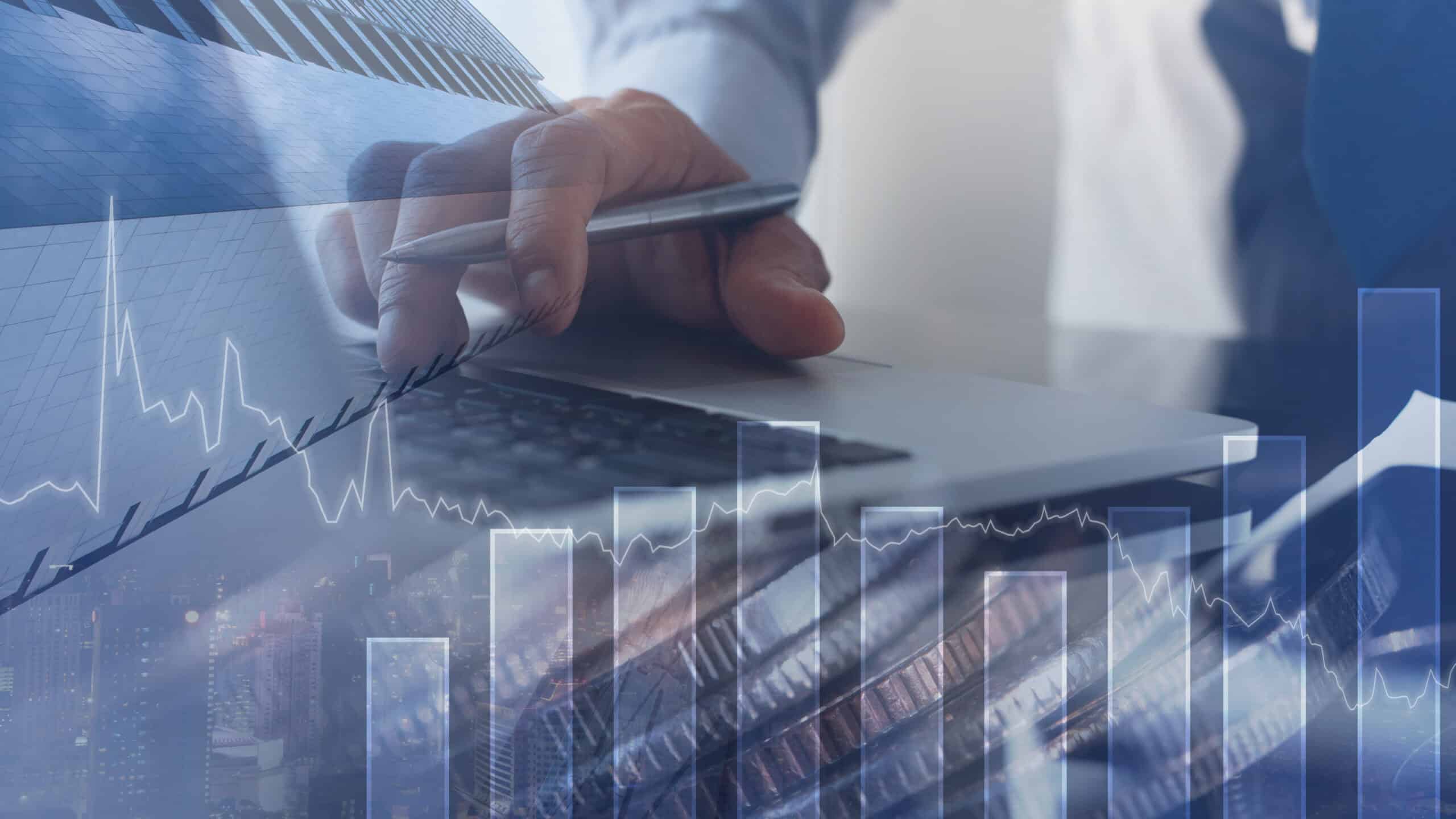 Man working in office with finance graph on virtual screen.
