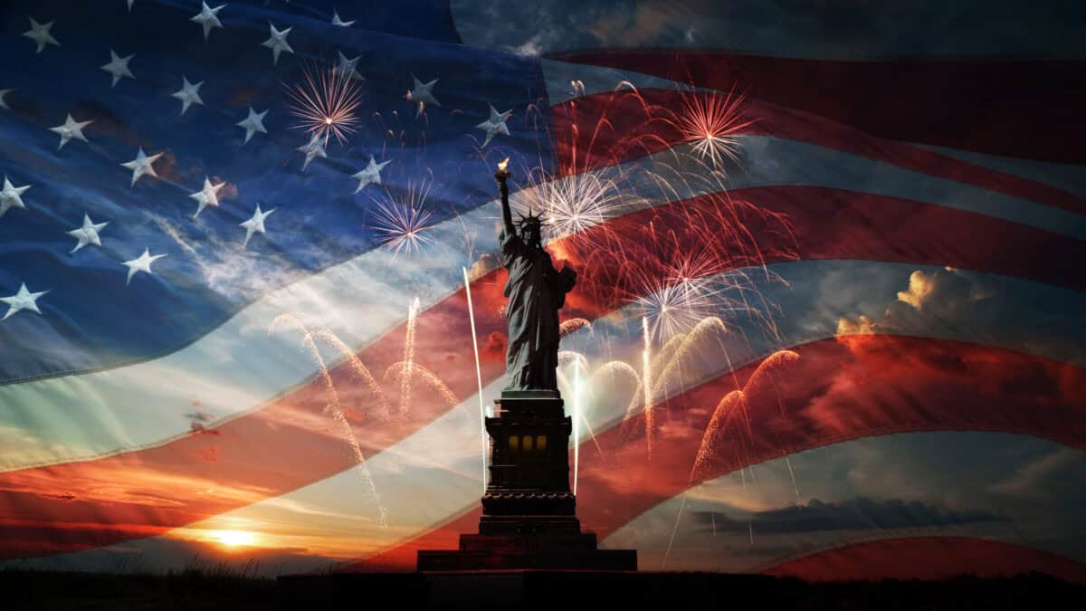 Statue of Liberty with the American flag in the background.