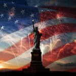 Statue of Liberty with the American flag in the background.