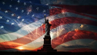 Statue of Liberty with the American flag in the background.
