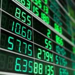 Stock market board with green numbers.