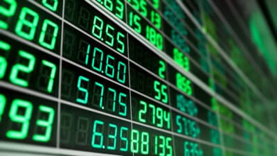 Stock market board with green numbers.