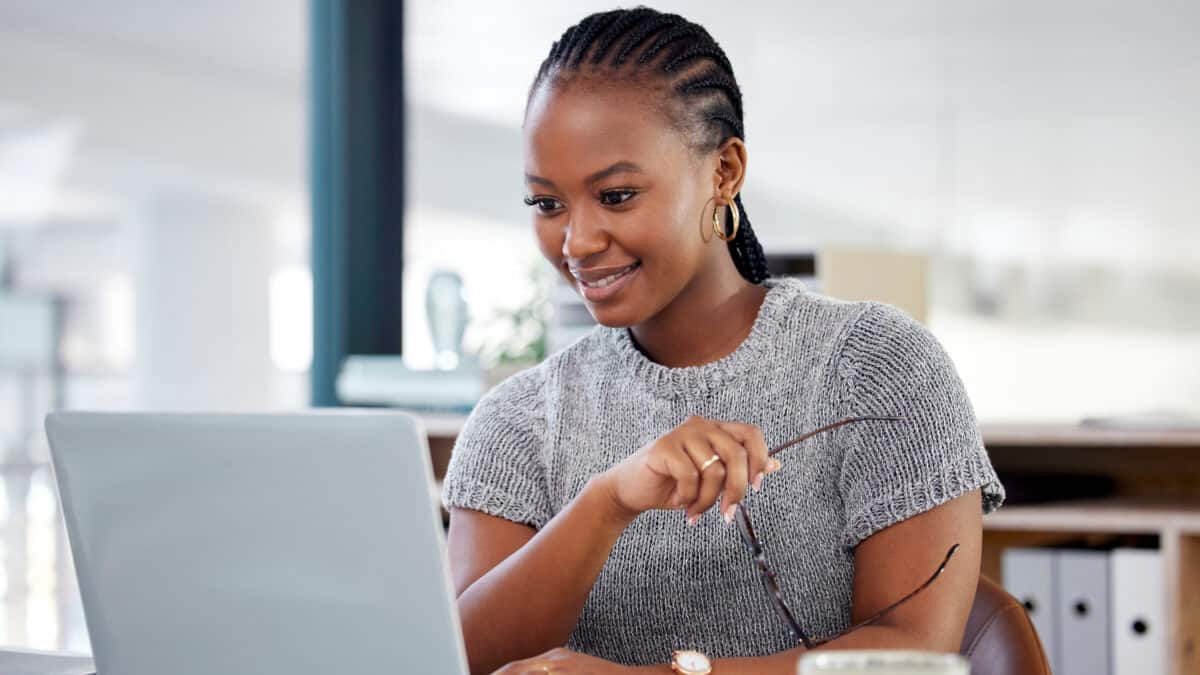 Happy woman looking at her laptop.