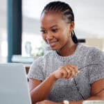 Happy woman looking at her laptop.