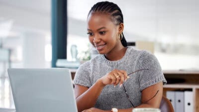 Happy woman looking at her laptop.