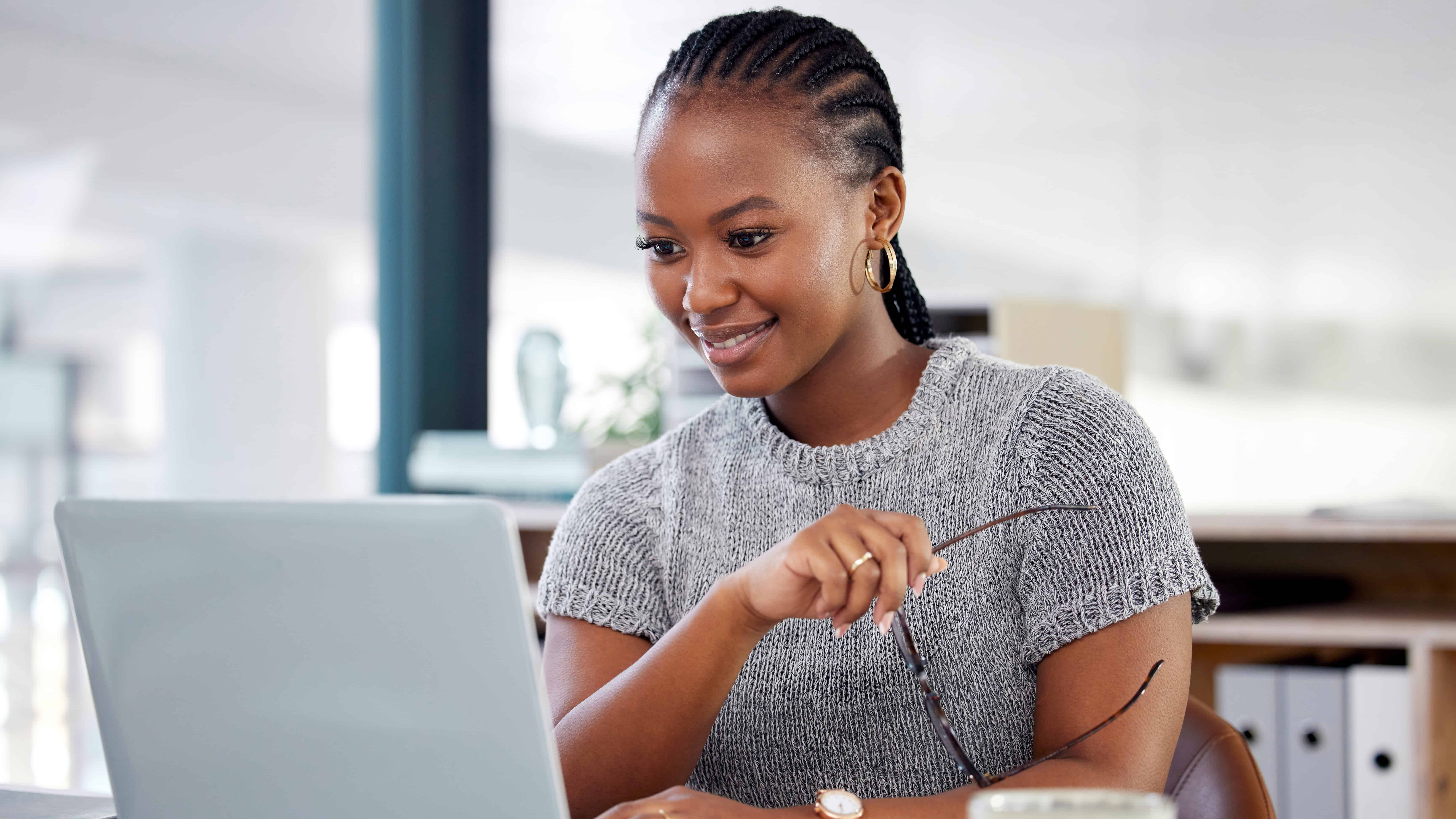 Happy woman looking at her laptop.