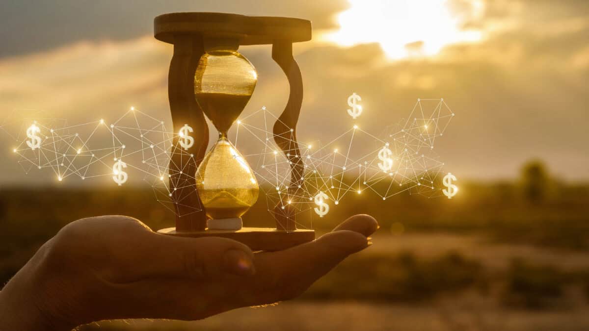 Hourglass in a hand with white lines and dollar signs.