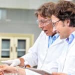 Two scientists analysing results on a computer screen.