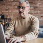 Man working on a laptop from home.