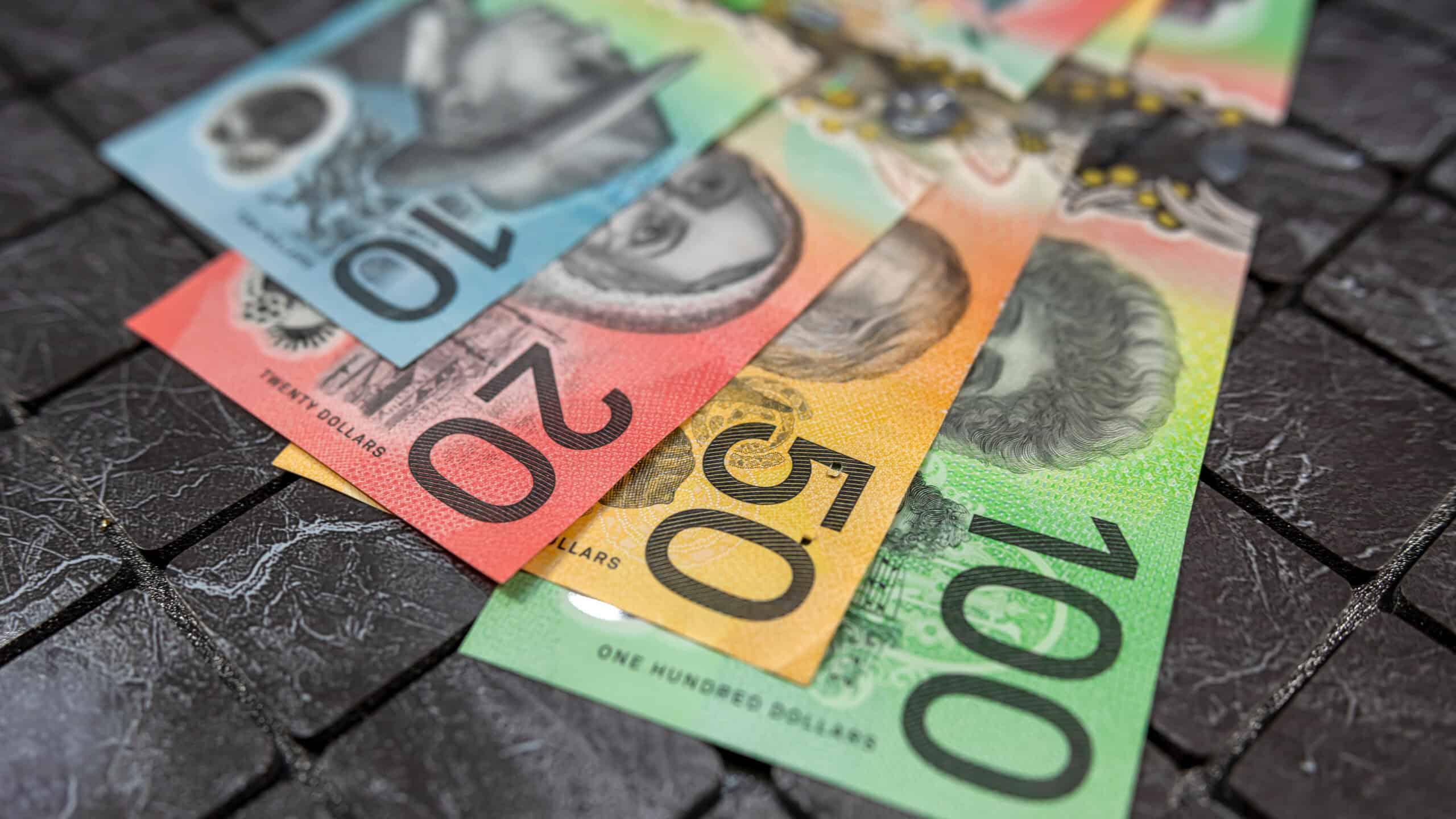 Numerous Australian dollar notes laid out.