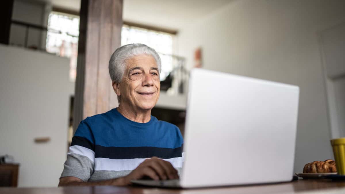 Pensioner looking at his laptop.