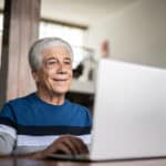 Pensioner looking at his laptop.