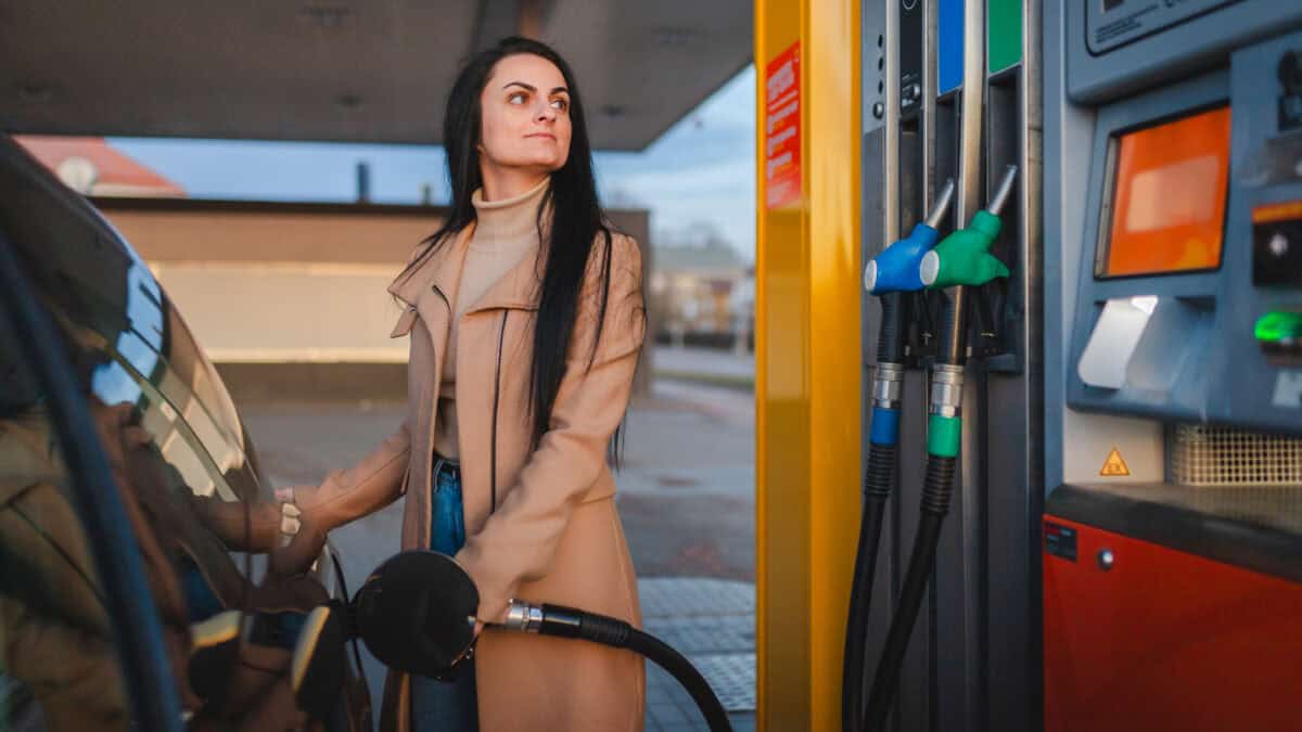 Woman filling her car with fuel.