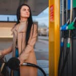 Woman filling her car with fuel.