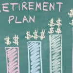 Retirement plan written on a chalkboard with increasing bar graphs and dollar signs on top.