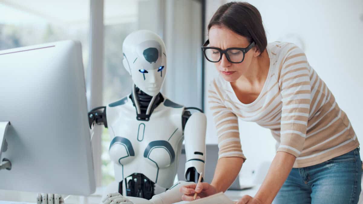 Woman and AI robot working together in the office.