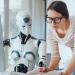 Woman and AI robot working together in the office.