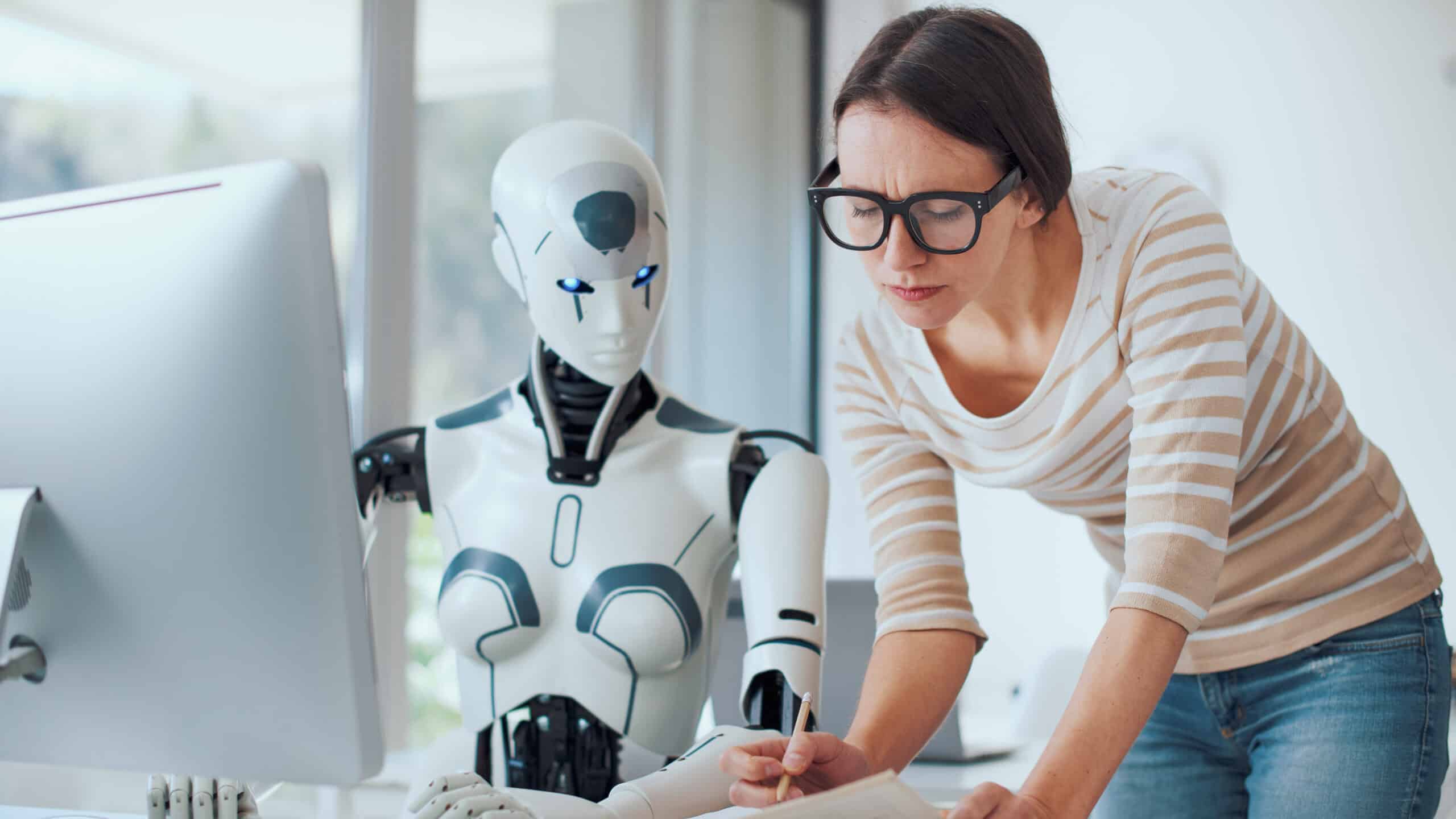 Woman and AI robot working together in the office.