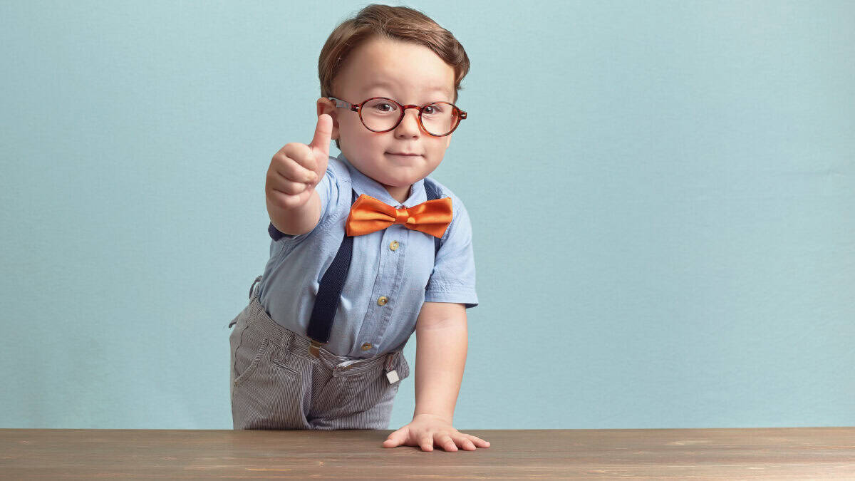 Small kid giving a thumbs up.