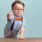Small kid giving a thumbs up.