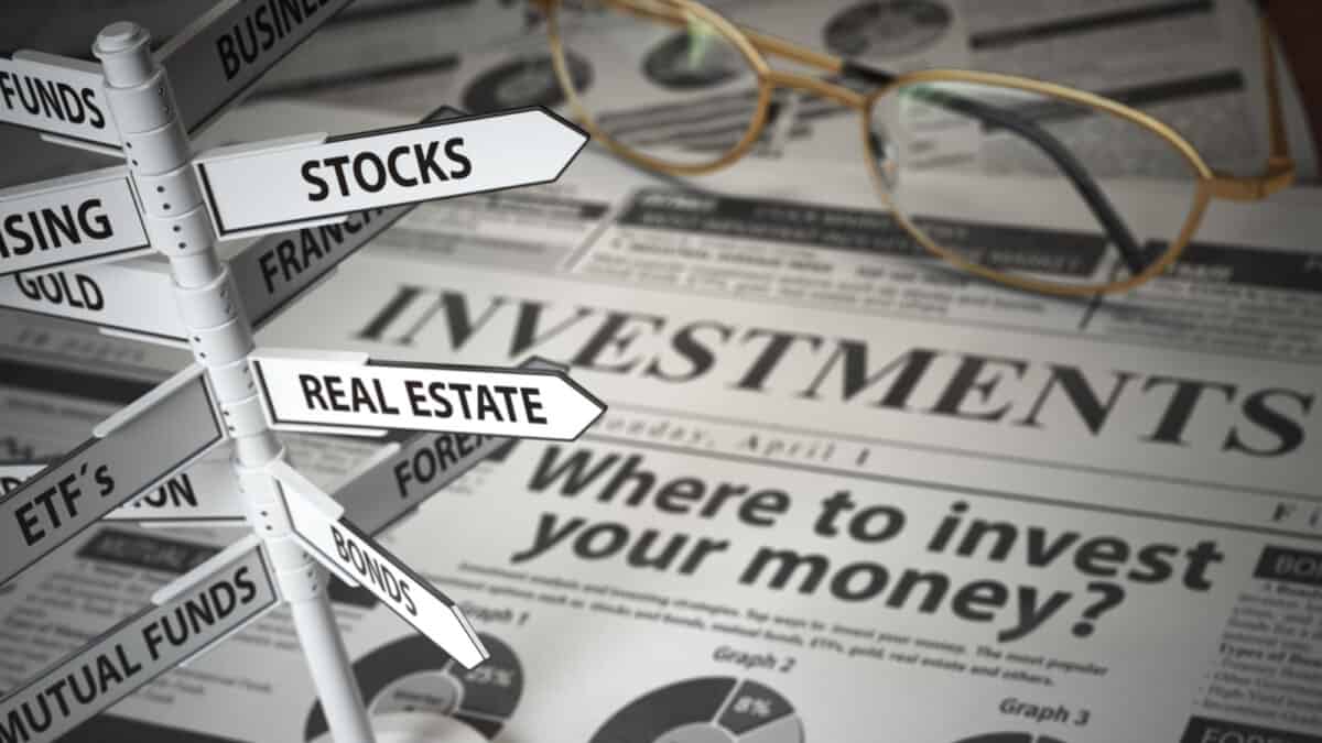 Signs of asset classes on a newspaper which says 'Where to invest your money?'.