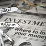 Signs of asset classes on a newspaper which says 'Where to invest your money?'.