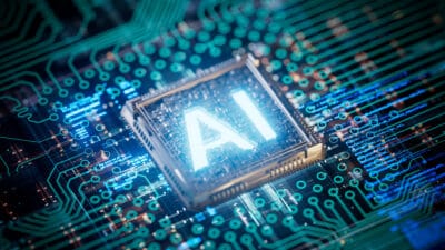 Glowing AI text in the middle of a semiconductor chip.