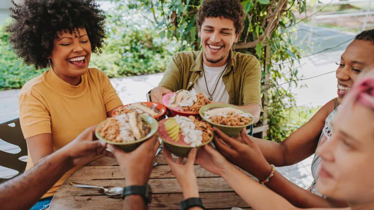 Five friends enjoying acai bowls at a cafe.