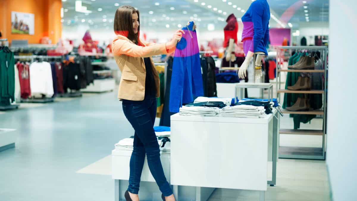 Woman checking out clothes at a shop.
