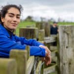 Woman smiling at a farm.