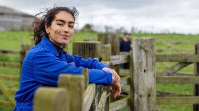 Woman smiling at a farm.